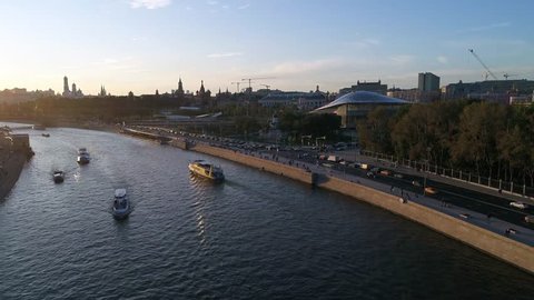 Moscow, Park Zariadye, soaring bridge, city, nature, people, architecture. September 2017. People crowds crossing the bridge. Multimedia, glass building, modern architect. Aerial steady,slow,footage.
