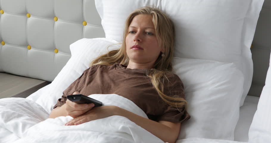Nervous Woman Lying In Bed Under Blanket Change TV Channel, Nervous Girl Sleeping