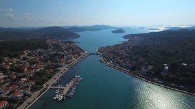 Panoramic aerial view to the neighborhood of a picturesque Croatian town, divided by a strait and connected by a bridge. 2K7 video.