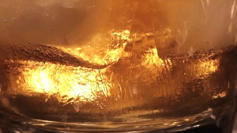 macro video of a glass of whiskey