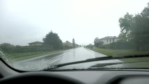 car driving under rain while windscreen wipers working