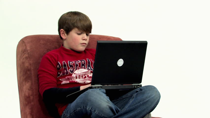 A young boy uses his laptop to do homework. -B-