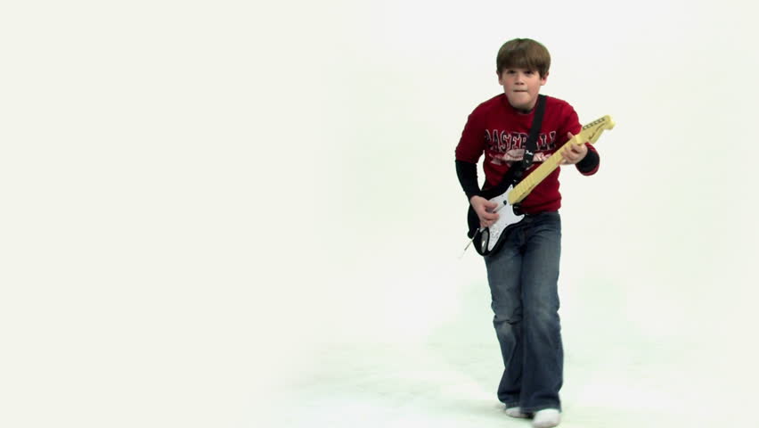 A young boy plays a guitar video game. -B-