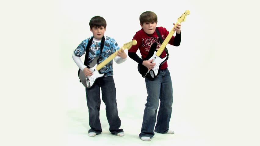 Two young boys play a guitar video game.
