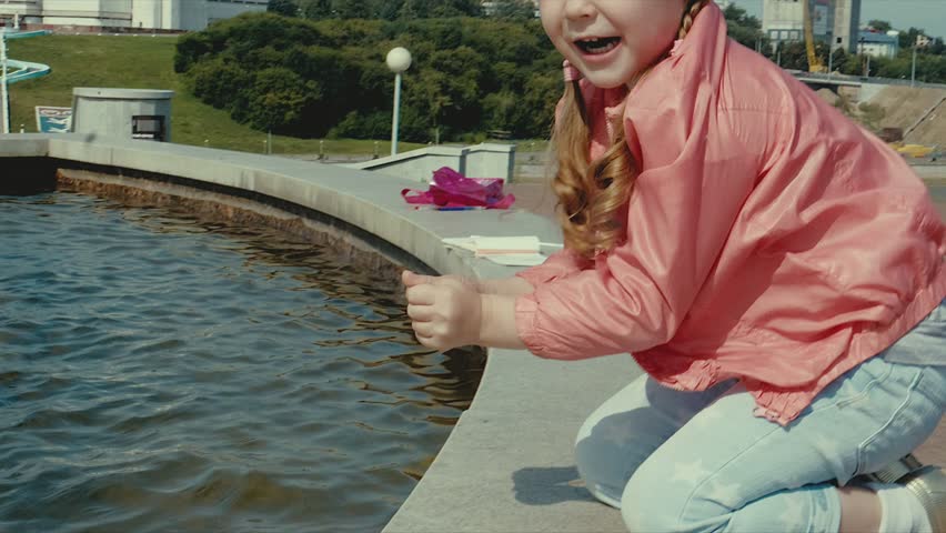 Beautiful girl is walking near the fountain 4k