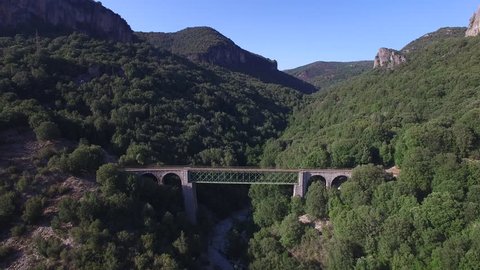 Stunning aerial overhead shot of old railroad going deeper into the mountains, Sardinia, Italy.