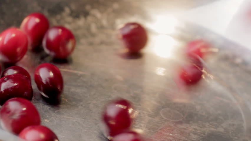 Cranberries pouring into bowl