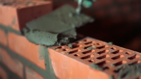 Brickwork process with trowel, closeup view and only hands visible