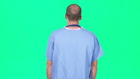 Green screen chromakey of doctor and heads up display, clicking with fingers, and looking at HUD. See my portfolio for other clips of reverse angle, with doctor facing forward. ProRes clip, 4K UHD.