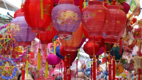 Crowded atmosphere on Luong Nhu Hoc street in sunny day. People visit, buy lantern, take photo with colorful lanterns, traditional culture on mid autumn. On lanterns not brand name or logo - Βίντεο στοκ