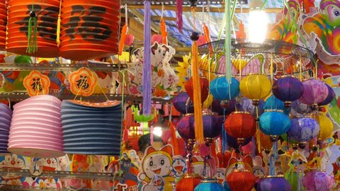 Crowded atmosphere on Luong Nhu Hoc street in sunny day. People visit, buy lantern, take photo with colorful lanterns, traditional culture on mid autumn. On lanterns not brand name or logo స్టాక్ వీడియో