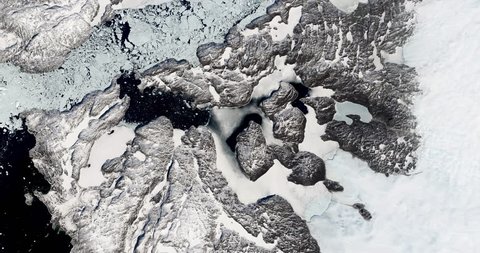 Very high-altitude overflight aerial of the rapidly receding Jakobshavn Glacier, Greenland. Clip loops and is reversible. Elements of this image furnished by NASA
