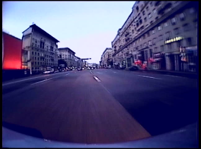 Car mount camera shot driving through the streets of city in a high speed 
