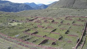 Drone flying around Peruvian ancient Inca ruins of Pikillacta. This beautiful ancient city is located on top of the mountain within the sacred valley of Peru.