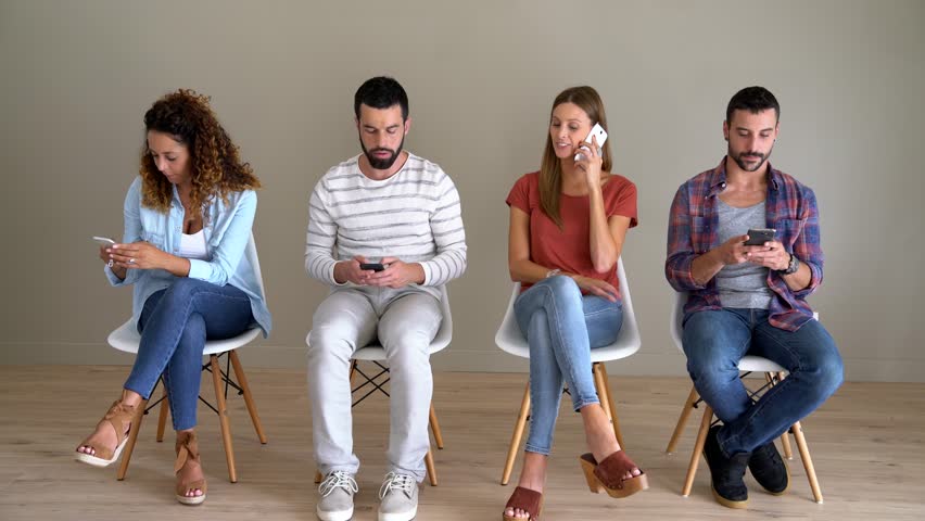 Young people in waiting room using smartphones Royalty-Free Stock Footage #30975415