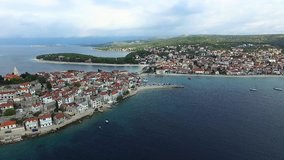 Aerial panorama of marina and resort adriatic town Primosten on cloudy day, Croatia. 2K7 video.