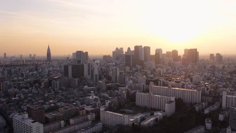 Japan Tokyo Aerial v151 Flying low over Shinjuku area panning cityscape views sunset