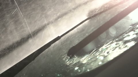 Windshield wiper with rain, during storm. Slow motion. Close up.