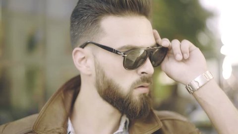 Bearded man portrait. Stylish hipster man face. Guy bearded in sunglasses. Close up of handsome bearded man sunglasses