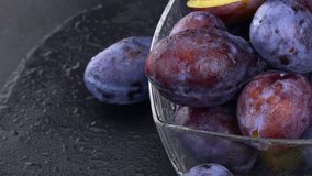 Portion of fresh Plums on a slate slab (4k; not loopable)