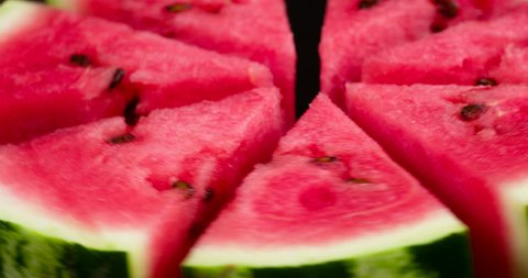 Plate with Slices of Watermelon. Video Loops. Triangular slices of watermelon rotate in front of the camera