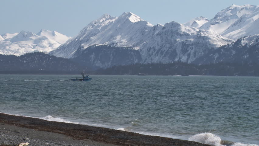 Fishing boat heading out in scenic waters