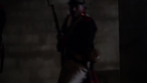 TEXAS - MARCH 2017 - Early 19th century Re-enactors representing Mexican Soldiers attack "Texians" with muskets and rifles. Men with black powder guns in stone fort. Soldiers attack the Alamo.
