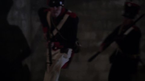 TEXAS - MARCH 2017 - Early 19th century Re-enactors representing Mexican Soldiers attack "Texians" with muskets and rifles. Men with black powder guns in stone fort. Soldiers attack the Alamo.