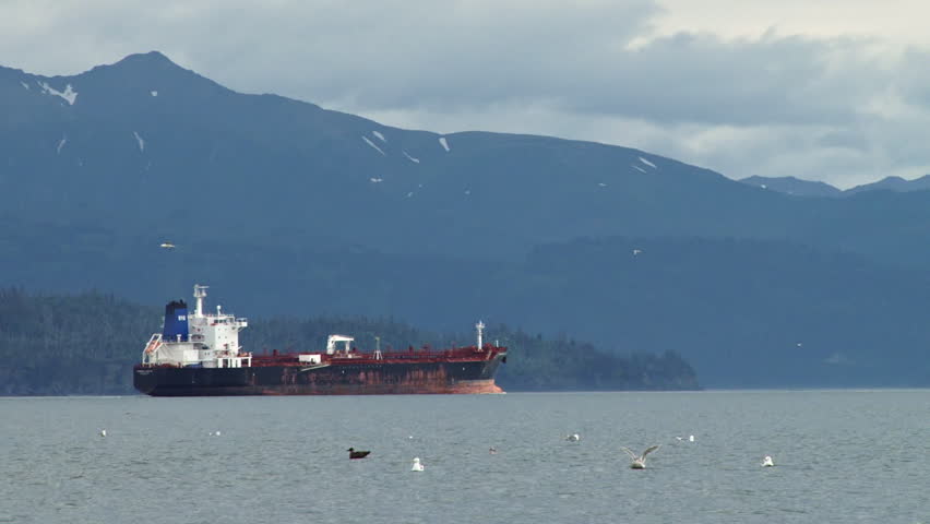 A dilapidated oil tanker returns from whence it came after taking on the Harbor