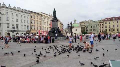 KRAKOW, POLAND - AUGUST 3, 2017: undefined people walking on the Market Square (Rynek Glowny) It is a biggest square measuring 200 meters on the side, and is the largest medieval square in Europe.