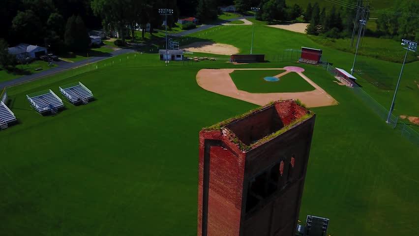 Drone circling an old smelting tower in a rural Wisconsin town