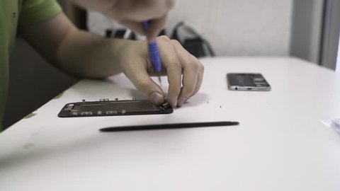 Technician repairing smartphone in the lab. 4K