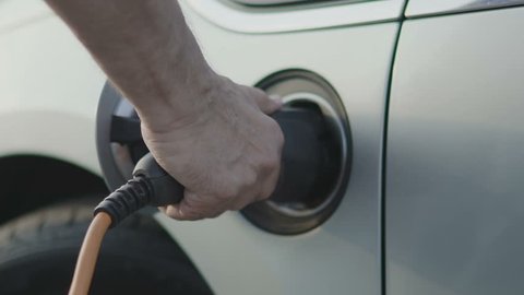 Charging of electric car. Slow motion 100 fps