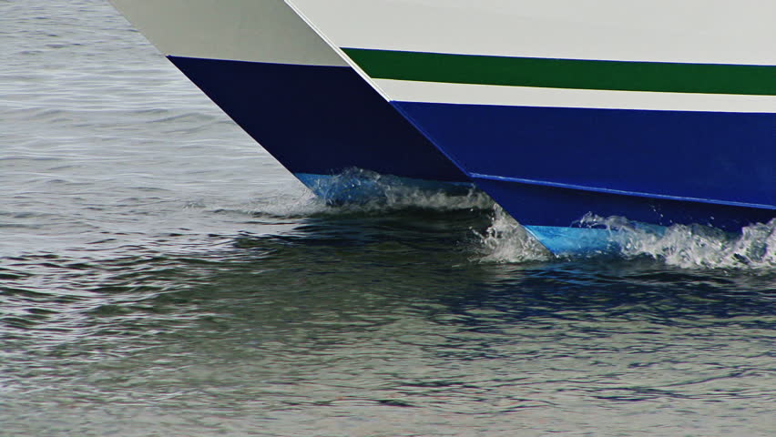 The leading edges of the bows of a double-hulled motor catamaran's hulls knifing