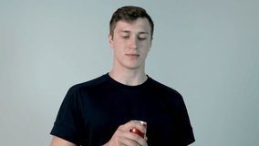Young man drinking soda. Young man in black shirt drinking soda, on a white background - Powered by Shutterstock - Get 15% off with code: PIKWIZARD15