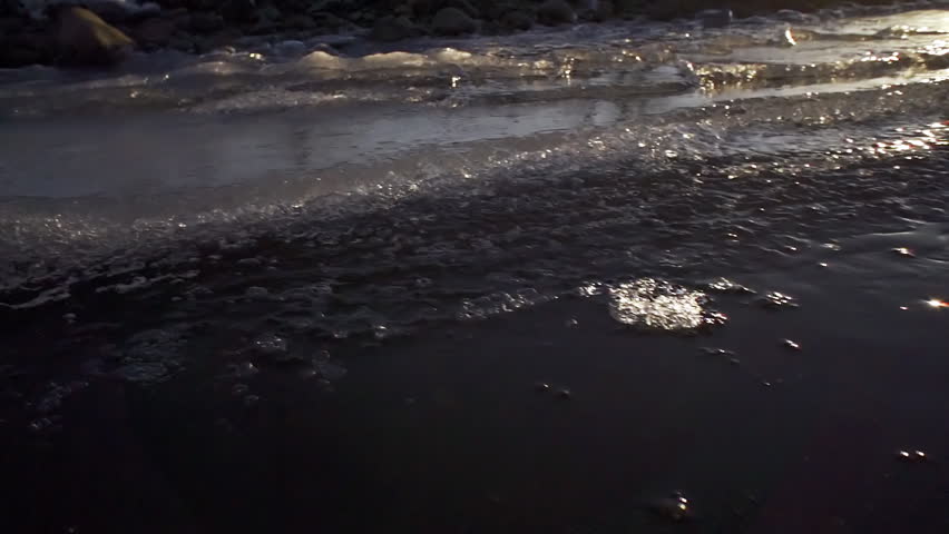 Camera with wide-angle lens focused on near ice formations at edge of river