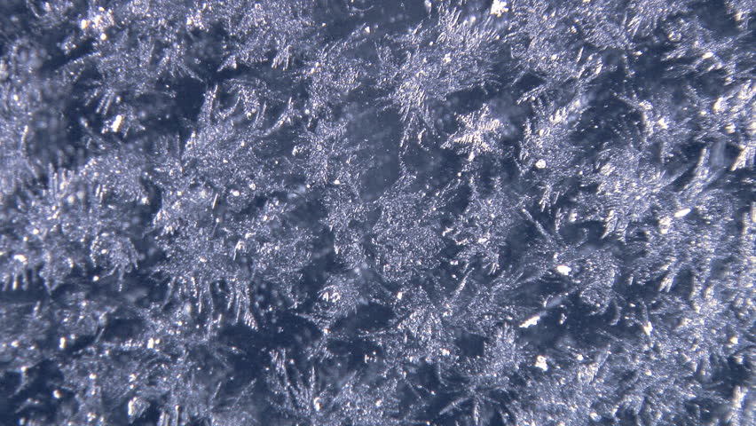 Intricate frost rime on a window, illuminated by a rotating light. Slower, and