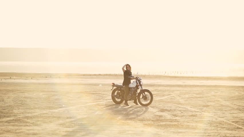 woman learning to ride a motorcycle