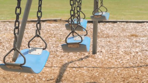 Empty swings at child playground loop 