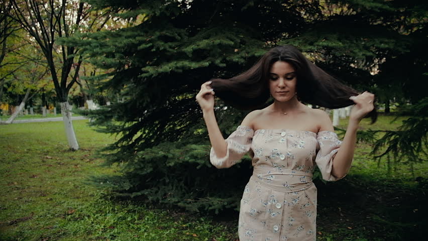 Happy beautiful woman walking in the city, steadicam shot 4k