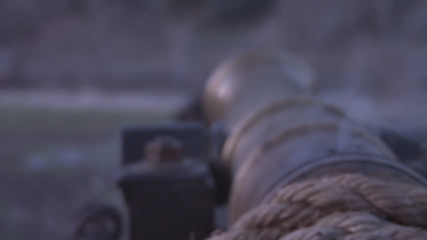 moody shot of a salute cannon's breech after firing - rack focus, handheld.