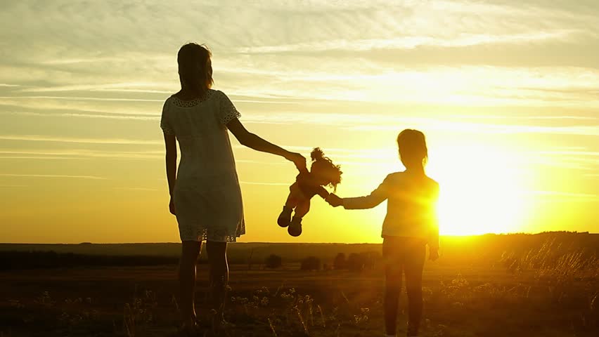Silhouette of mom and daughter at sunset, holding toy doll and staring into the distance. Silhouette of girl play with dolls | Shutterstock HD Video #31020277