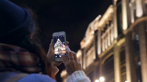 Tourist Girl Photographing with Mobile Phone Historical Building at Night Streets of Saint-Petersburg, Russia. 4K, Slowmotion.