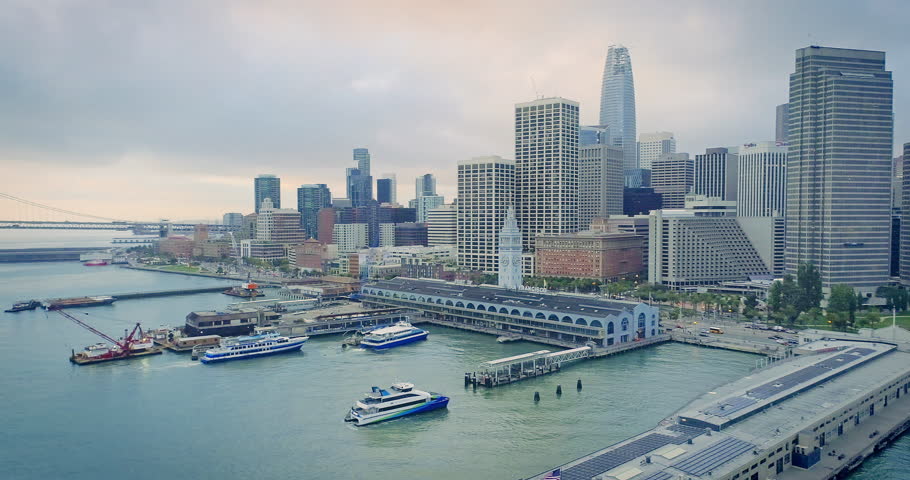 Aerial: San Francisco Embarcadeo, Ferry Building, bay bridge & cityscape at sunrise
