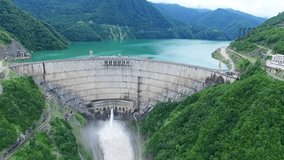 Dam in Mountain Landscape Aerial static view 4k video. Green Alternative renewable Energy Electric Power technology scene.
