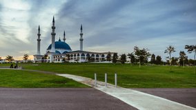 Bandar Dato Onn Mosque in Johor Bahru, Malaysia at sunset with fast motion sky. 4k video footage. Camera pan left motion.