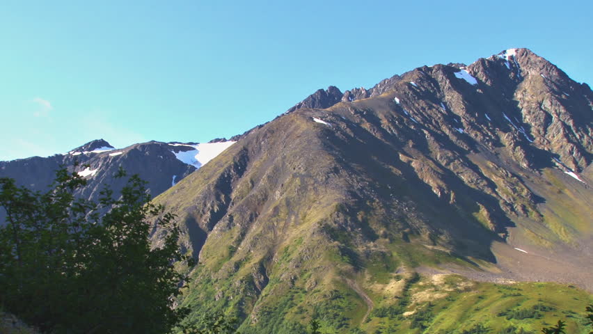 Pan, left to right, mountains in Alaska, summertime.