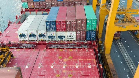 Bangkok, Thailand, 12 April 2017 : 4K time-lapse video of Container Cargo freight ship with working crane loading bridge in shipyard at dusk for Logistic Import Export background