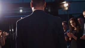 Award ceremony concept, young attractive bearded man in strict clothes with trophy in hands moving across red carpet, crowd of people applause - Powered by Shutterstock - Get 15% off with code: PIKWIZARD15