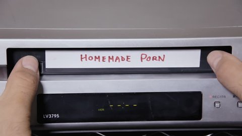 Inserting and removing a VHS tape from a VCR. The title says Homemade porn.
